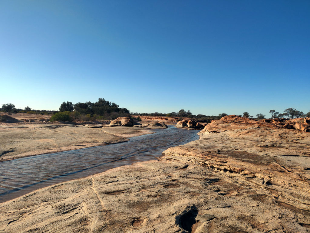 Waterholes over rock sheets